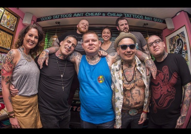 Artists inside Allstar Ink Tattoo on Wickham Street, Limerick, in front of flash frames — from the studio’s own photo
